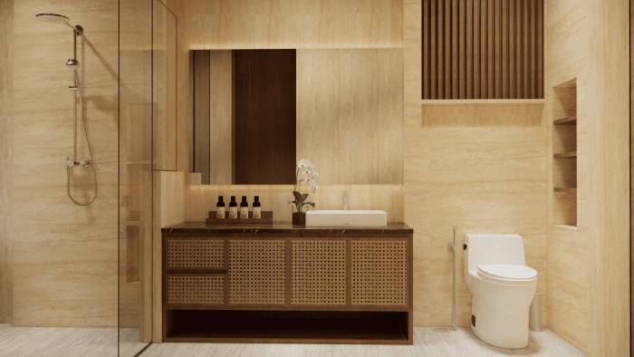 Modern bathroom featuring a glass shower, rattan vanity with vessel sink, large mirror, and a toilet with warm travertine-like tiles.