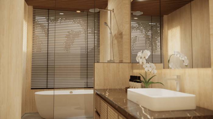 Modern bathroom with a freestanding tub, shower, wood vanity, rectangular sink, mirror, and white orchids.