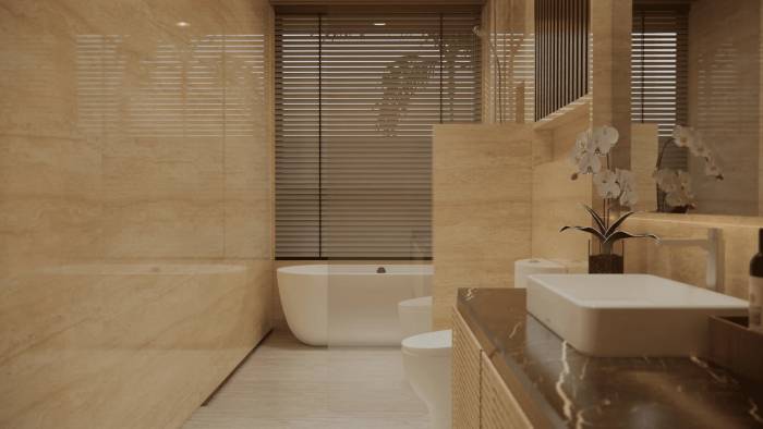 A luxurious bathroom with polished marble walls, a freestanding tub, and a modern vanity with orchids.